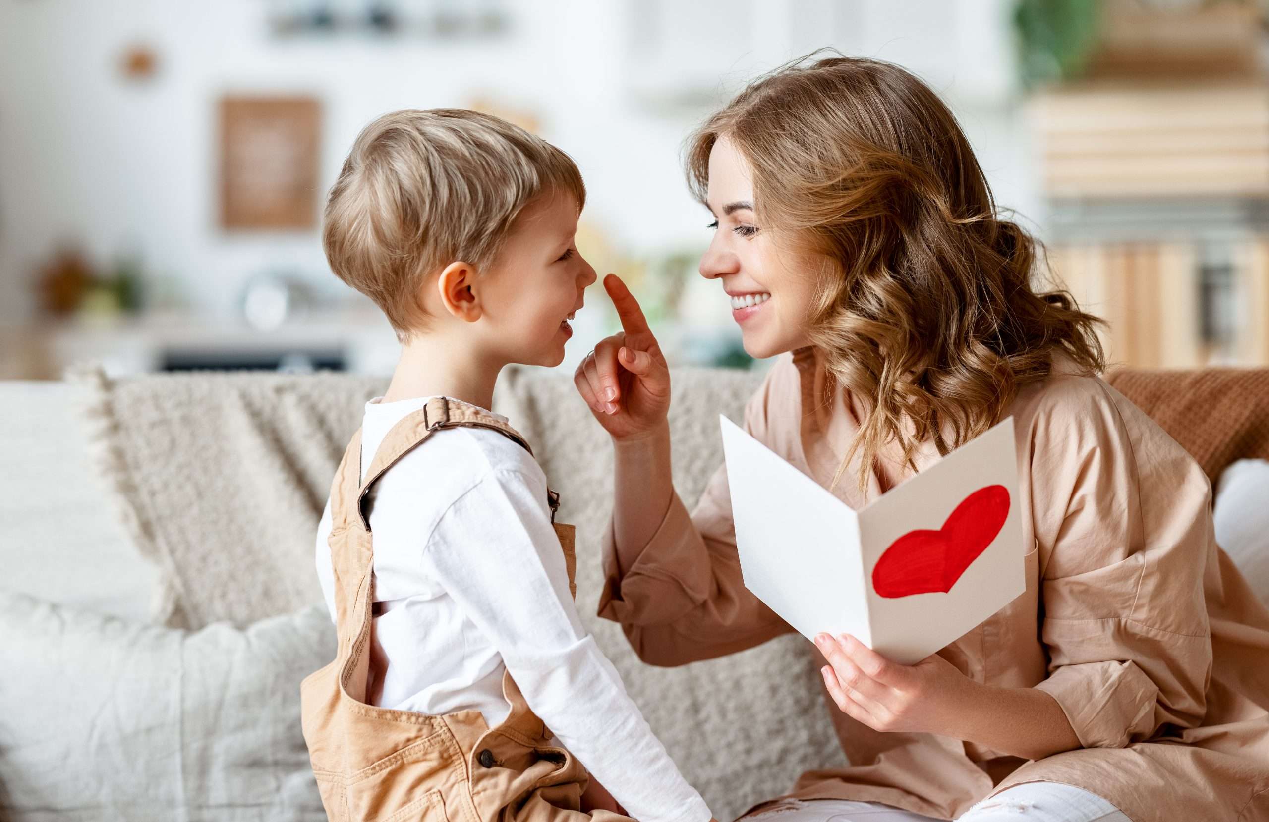 Mother and son reading together. Both smiling and happy